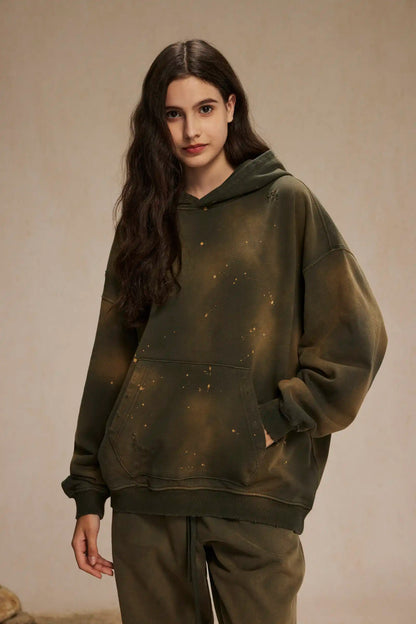 Spray-stained ink holes worn hoodie