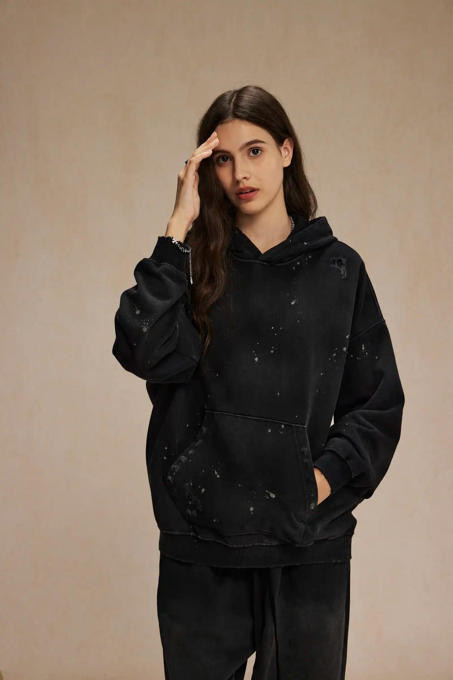 Spray-stained ink holes worn hoodie