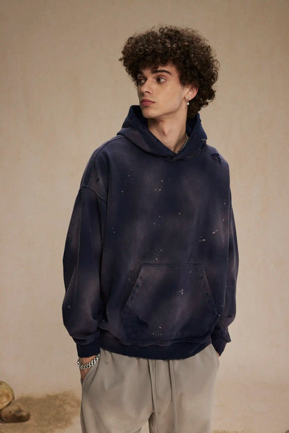 Spray-stained ink holes worn hoodie