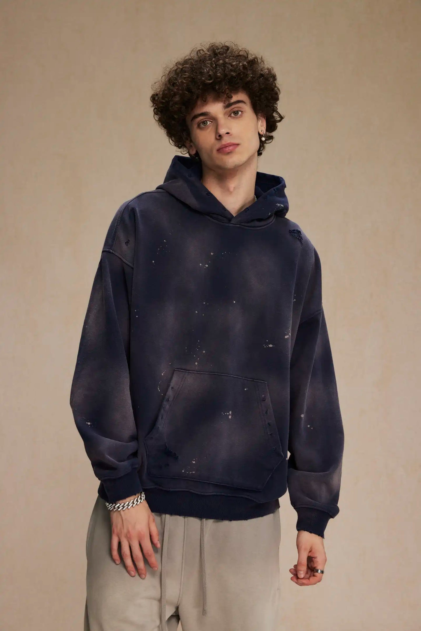 Spray-stained ink holes worn hoodie