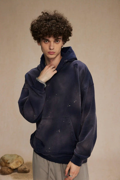 Spray-stained ink holes worn hoodie