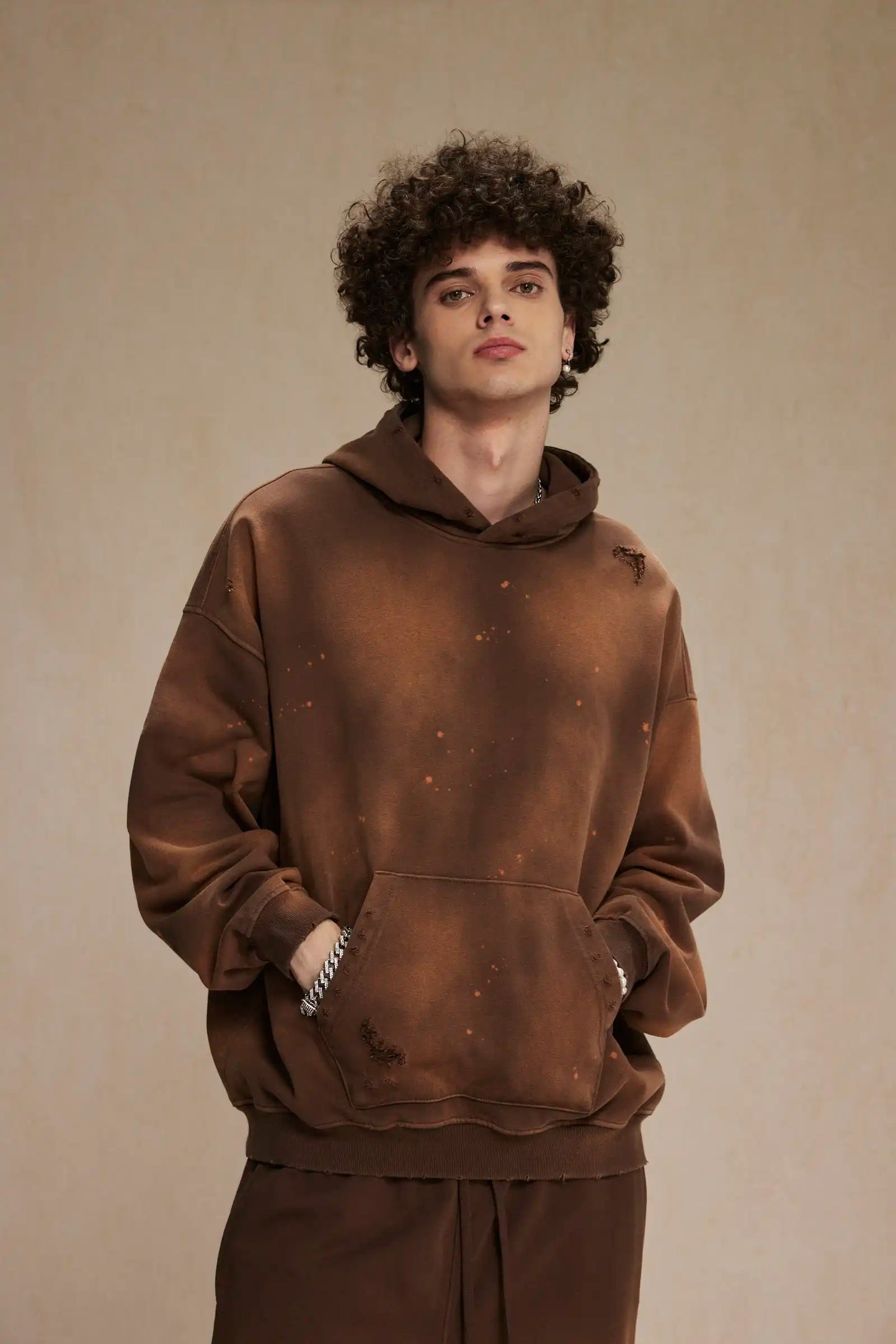 Spray-stained ink holes worn hoodie