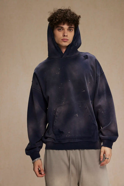 Spray-stained ink holes worn hoodie