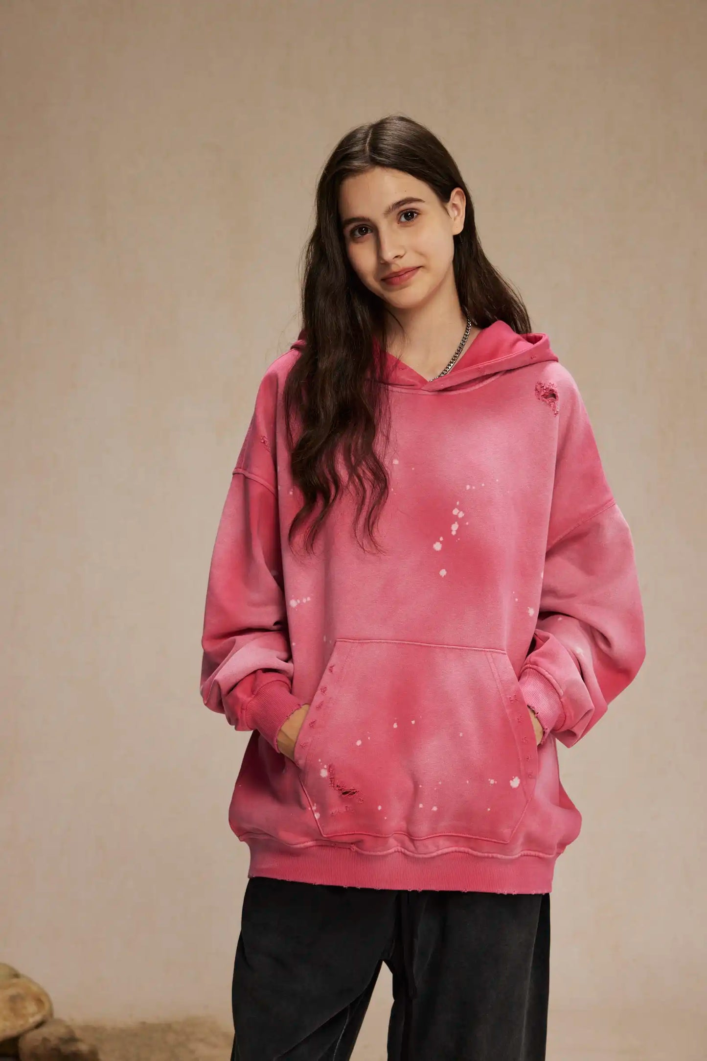 Spray-stained ink holes worn hoodie