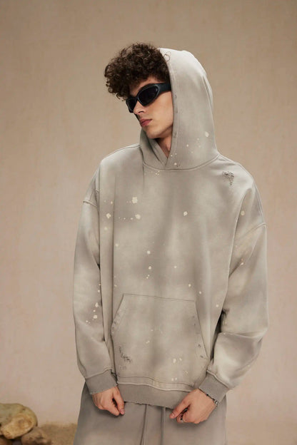 Spray-stained ink holes worn hoodie